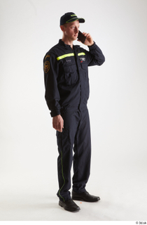 Sam Atkins Fireman with Mobilphone standing talking whole body 0008.jpg